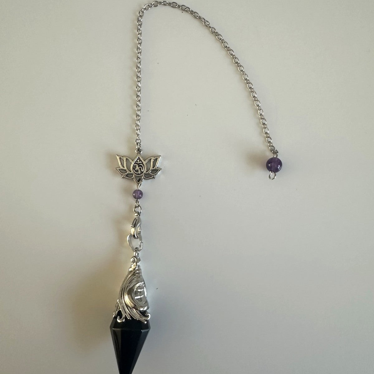Black stone pendulum with lotus charm